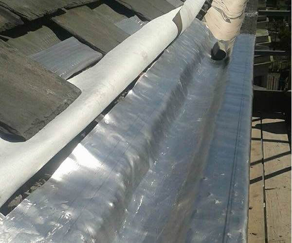 roofing work - stone guttering repairs during